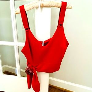 Free People crop top with tie waist. Fun patterned detailing. Size:Medium